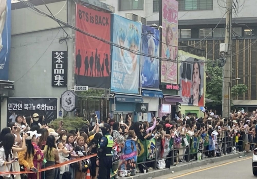 Fans gather near HYBE headquarters for RM and V’s discharge