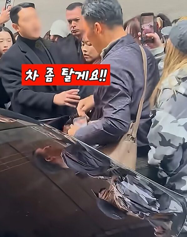 Bodyguard shouting to clear way