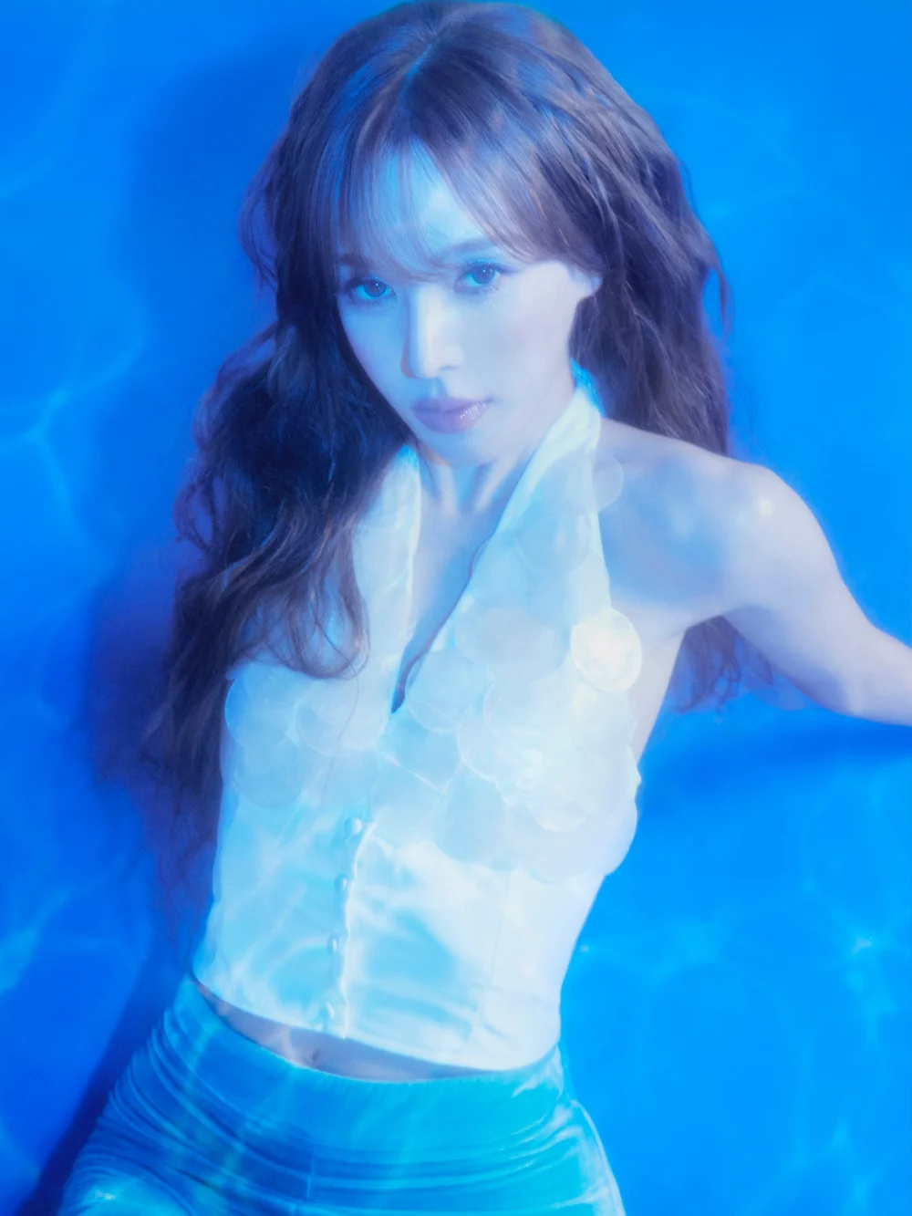 member silhouetted against a textured blue underwater scene