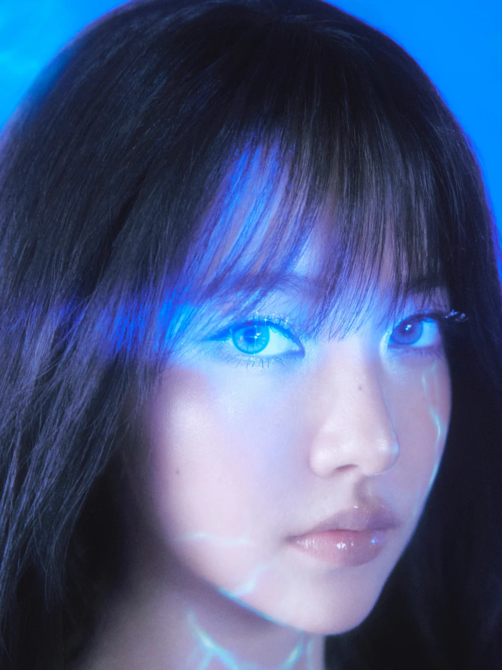 member gazing toward camera with marine-inspired background