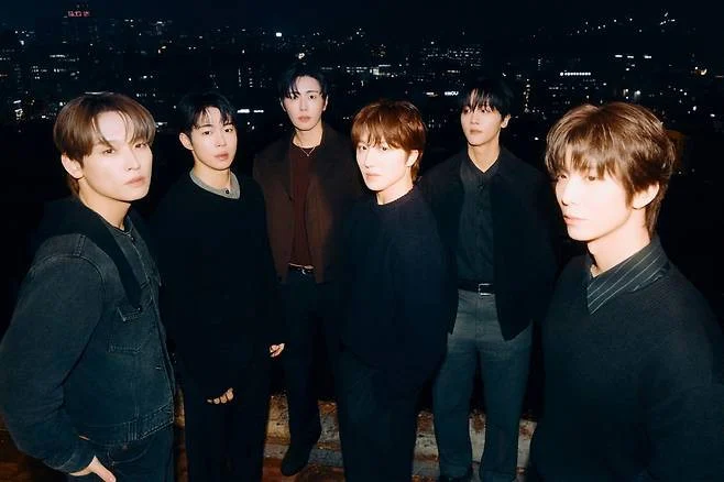 SF9 members posing for promotional anniversary album photo