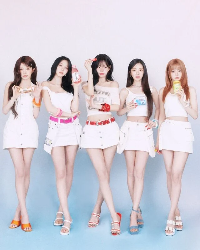 fromis_9 members holding Show Champion trophy smiling on stage