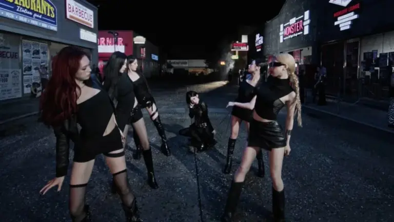 BABYMONSTER members in coordinated all-black outfits on a darkened street