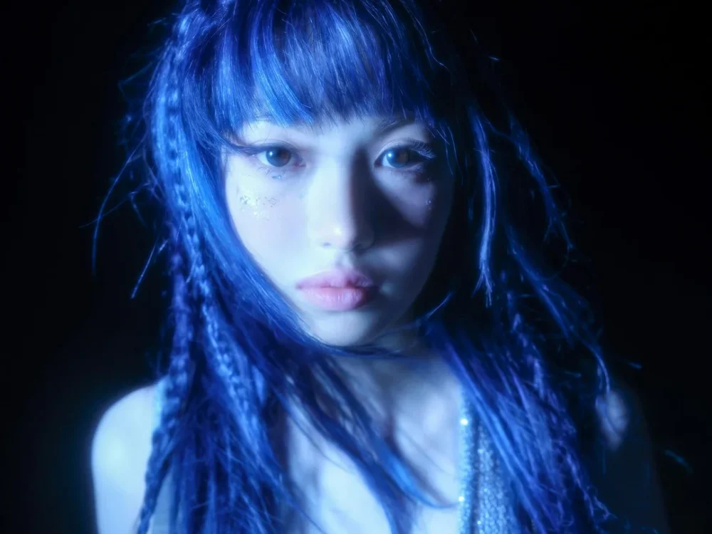 Group arranged on a dim, moonlit backdrop with ethereal styling