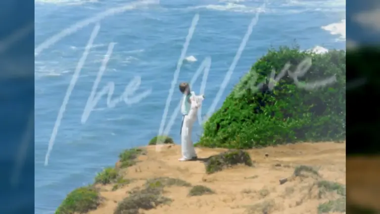 Kim Jae Joong standing on a seaside cliff feeling the ocean breeze