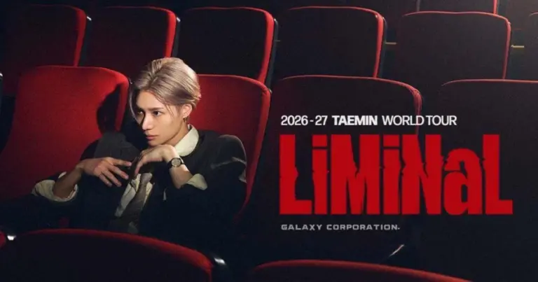 TAEMIN performing on stage in a dramatic pose during concert