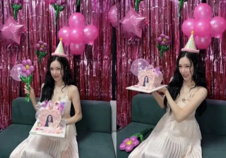 Tiffany Young holding a cake in a room decorated with balloons